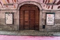 Old medieval wooden door alongside the pink street in Lisbon