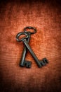 Old medieval wrought iron keys on red background