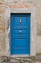 Old mediterranean blue door with marble jambs in the small village of Nicola in Italy Royalty Free Stock Photo