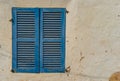 Vintage blue window shutter with old plaster wall background texture Royalty Free Stock Photo