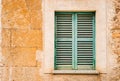 Vintage green window shutter and rustic stone wall background Royalty Free Stock Photo