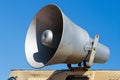 Old megaphone on background of sky, speaker loudspeaker Royalty Free Stock Photo