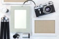 old memories concept - retro camera and empty photo frames on white wooden desk Royalty Free Stock Photo