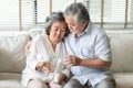 Old man comforting his wife. Elderly woman holding pills or medicine on her hand while having fever