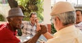 Old Men Shaking Hands Winning Game Of Domino Royalty Free Stock Photo