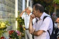 Old men standing in front of the Wall of Remembrance put flowers. Meeting devoted to the anniversary of the battle of Royalty Free Stock Photo