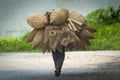 Old men are walking for selling wicker craftsman making traditional bamboo fish trap or weave in Hanoi, Vietnam