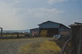 The old metal barn full of hay on the rusty barn under the dusty sky Royalty Free Stock Photo