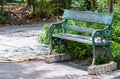 Old metal bench with the watering hose Royalty Free Stock Photo