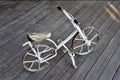 Old metal bicycle stands on a wooden platform Royalty Free Stock Photo