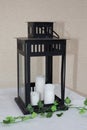Old metal black lantern with white candle on table home decorative design Royalty Free Stock Photo