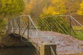 Old metal bridge in autumn park Royalty Free Stock Photo