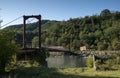 Old metal bridge over a mountain river Royalty Free Stock Photo