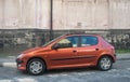 Old metal brown small cheap compact car Peugeot 207