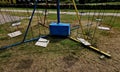 an old metal carousel with a chain of seats on the lawn at the school. the Royalty Free Stock Photo