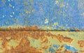An old metal case with bright orange spots of rust through several layers of paint.Peeling paint on old rusty metal Royalty Free Stock Photo