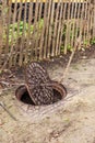 Old metal cast iron canal hatch. Dangerous open unsecured hatch on the road. A broken iron manhole cover opened dangerously in Royalty Free Stock Photo