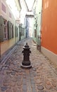 Old metal decorative stand on a narrow pedestrian street in the Latvian capital Riga at the end of April 2020