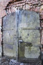 An old metal door in the brick wall Royalty Free Stock Photo