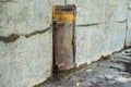 Old metal door in a concrete wall