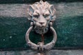 Old metal door handle in the form of a lion head. Venice, Italy Royalty Free Stock Photo