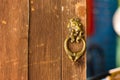 old metal door handle knocker on wood door Royalty Free Stock Photo