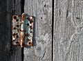 Old metal door hinge on wooden door