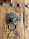 Old Metal door knocker on studded wooden door. Royalty Free Stock Photo