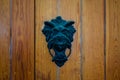 Old metal door knocker on a wooden door Royalty Free Stock Photo