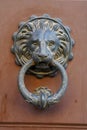 An old metal door knocker on a wooden door Royalty Free Stock Photo