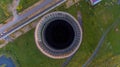 Old metal factory chimney in Caen Colombelles, Normandy, drone photo at sunset, industrial area