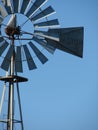 Old metal farm windmill with blue sky Royalty Free Stock Photo