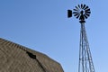 Wind mill casts a shadow of barn roof Royalty Free Stock Photo