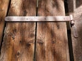 Old metal fastening to wooden doors or gates, rustic constructions Royalty Free Stock Photo