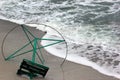 Old metal frame of beach umbrella on a seashore. Waves on a sand Royalty Free Stock Photo