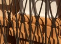 Old metal gate shadow on orange plaster wall. Royalty Free Stock Photo
