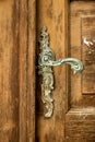 Old metal handle on wooden door Royalty Free Stock Photo