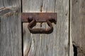 An old metal handle on a wooden door Royalty Free Stock Photo