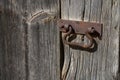 An old metal handle on a wooden door Royalty Free Stock Photo