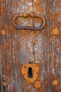 An old metal handle on a wooden door Royalty Free Stock Photo