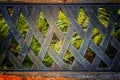 The old metal handmade back texture of the bench with ferns view Royalty Free Stock Photo