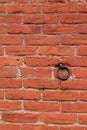 Old metal hook in red brick