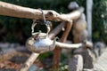 Old metal kettle on a wooden fence. Rural scenery. Traditional old Slovenian Ukrainian kettle hanging on a wattled fence