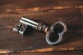 Old metal key on a wooden background Royalty Free Stock Photo