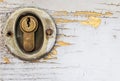 Old metal keyhole lock on a old crack paint wooden door Royalty Free Stock Photo