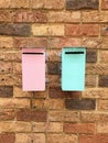 old metal letterboxes against brick wall