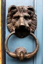 Old metal lion door knocker on blue painted wooden door Royalty Free Stock Photo