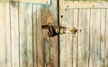 Old metal lock hanging on wooden barn door Royalty Free Stock Photo