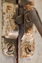 Old metal lock on a white wooden window frame. Old wooden window frame with a small rusty lock. Royalty Free Stock Photo