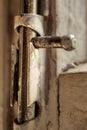 Old metal lock on a white wooden window frame. Old wooden window frame with a small rusty lock. Royalty Free Stock Photo